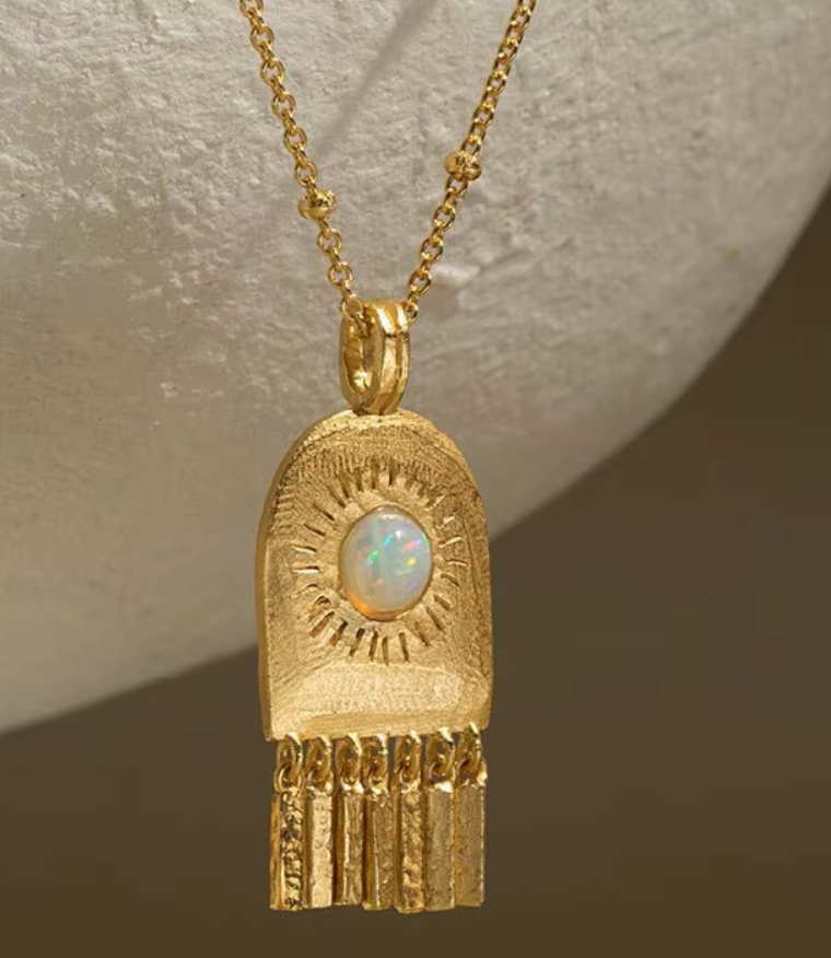 Open Door Solar Chime Amulet Necklace on Brown Background