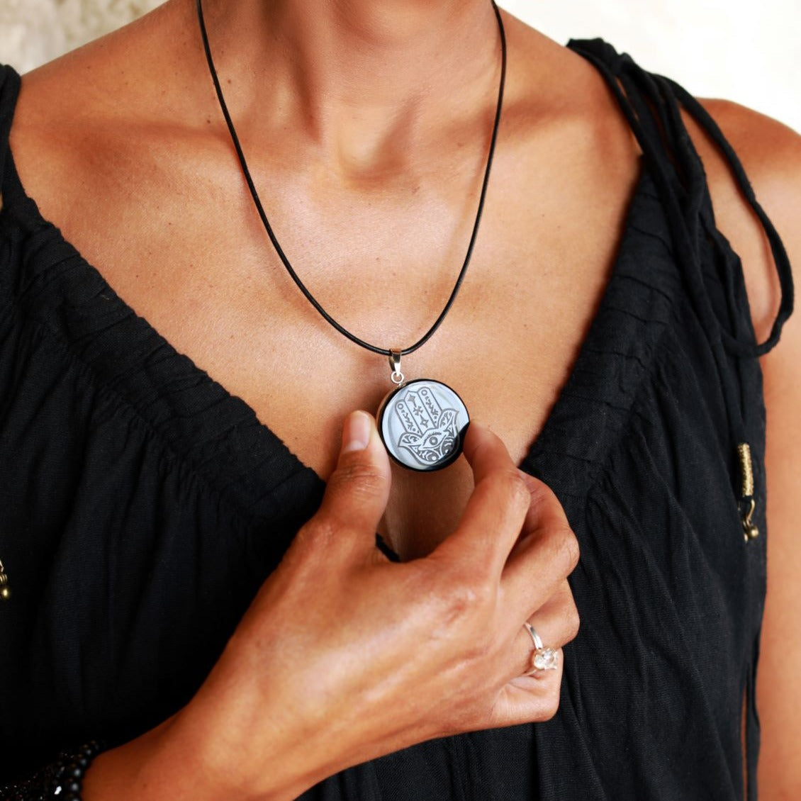 Obsidian Hamsa Necklace with Leather Cord on Model