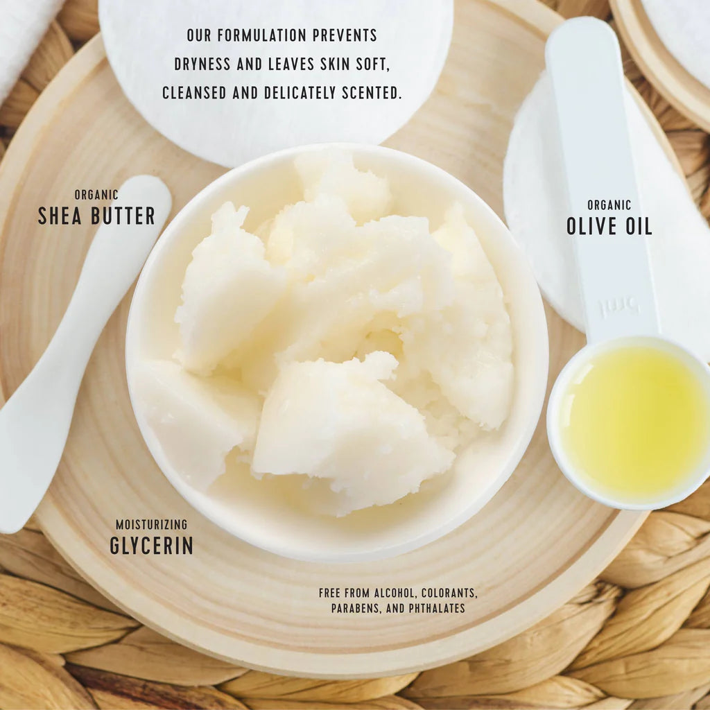 Bowl of shea butter with olive oil and text about product benefits on a wooden surface.